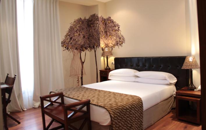 Postel nebo postele na pokoji v ubytování Hotel el Jardín de Eugenia