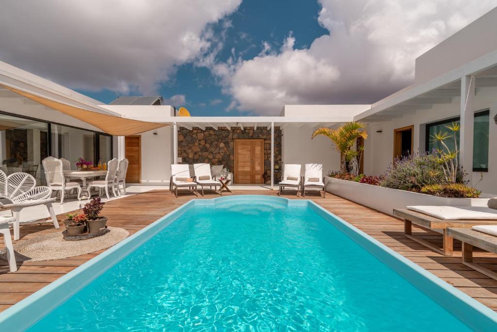 a villa with a swimming pool and a patio at Villa Shepherd Lajares - LUXURY VILLA FUERTEVENTURA in Lajares