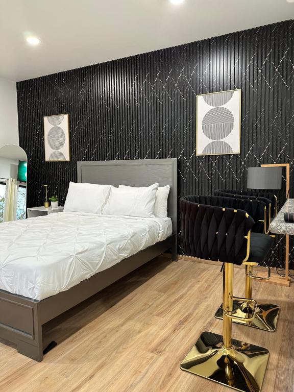 a bedroom with a bed and a black wall at Robyn’s Nest in Scarborough