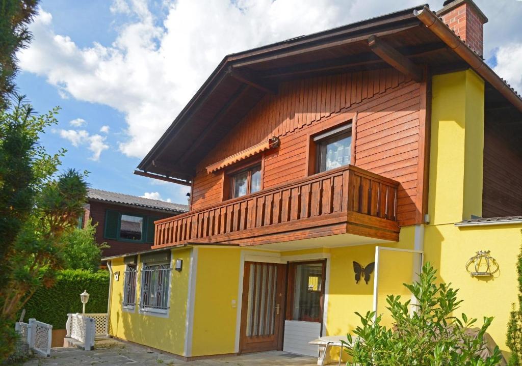 a house with a wooden balcony on top of it at Moderne Ferienwohnung in Pöls mit Großer Terrasse - b48832 in Pöls