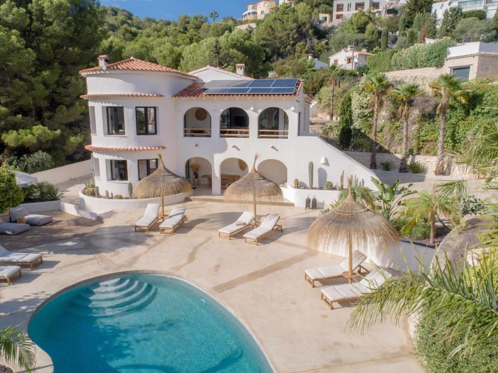 a villa with a swimming pool and a house at CostaBlancaDreams Casa Capritxu in Benissa in Fanadix