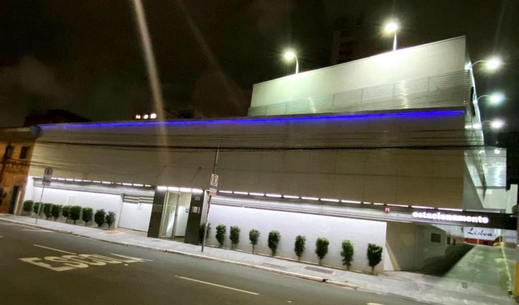 a building with blue lights on the side of a street at Hotel Nova Lisboa - Adult Only- in Sao Paulo