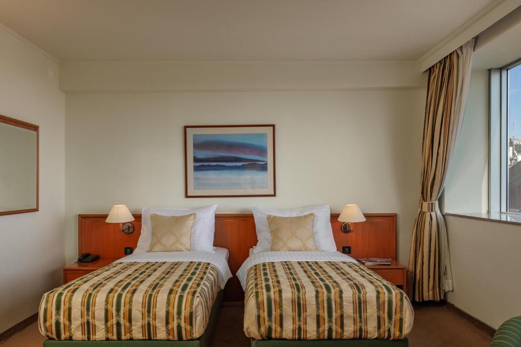 Postel nebo postele na pokoji v ubytování Grand Hotel Bonavia