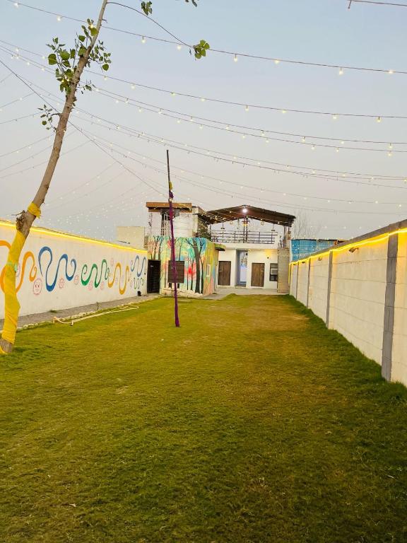 a building with a wall with graffiti on it at Shimmer Farms in Faridabad