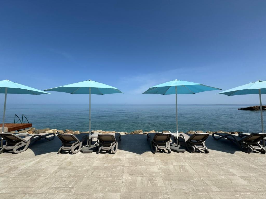 a group of chairs and umbrellas on a beach at High Life in Kyrenia