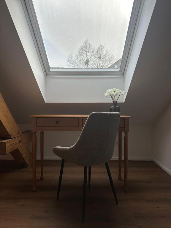 a desk with a chair and a window at Peterhof Sarnen in Sarnen