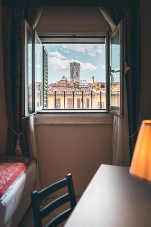 Postel nebo postele na pokoji v ubytování Hotel Palazzo Benci