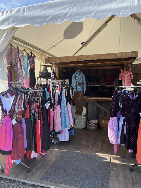 a group of clothes on display in a tent at Wies'n Camp in Munich