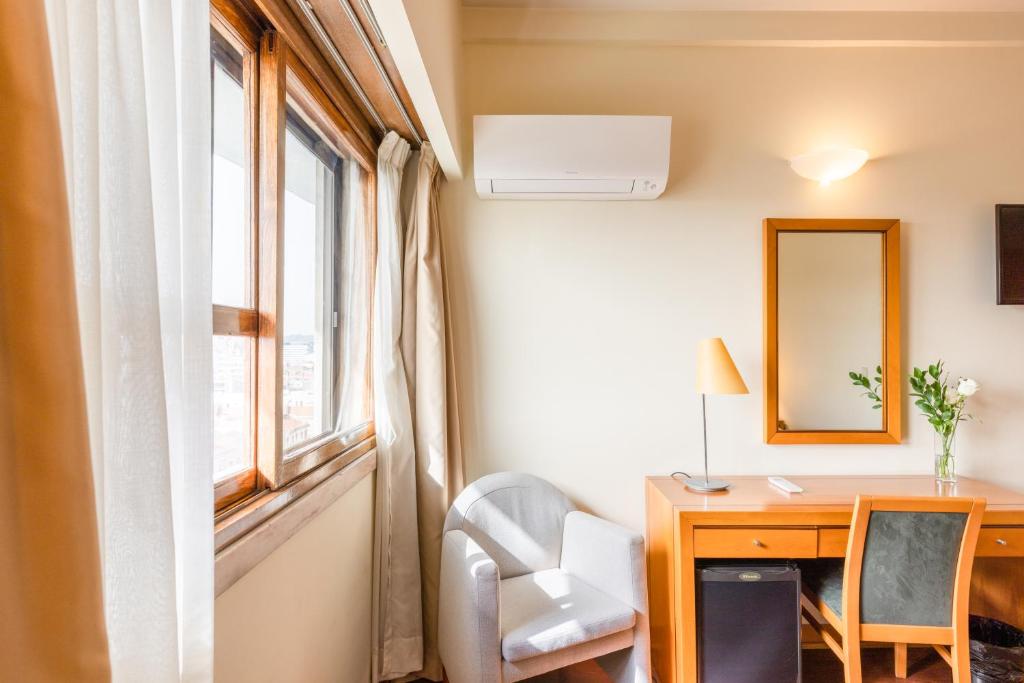 A compact in-room workspace beside a city-facing window.