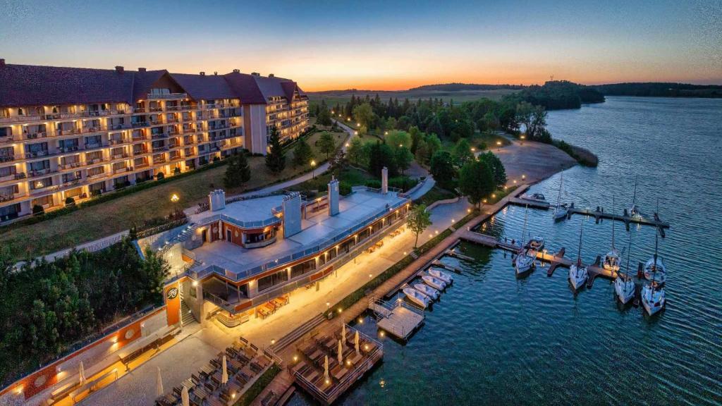 an aerial view of a hotel on the water at Hotel Gołębiewski Mikołajki in Mikołajki