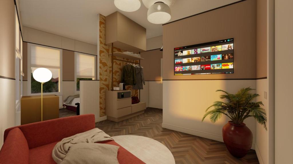 - un salon avec un canapé et une télévision murale dans l'établissement Brera Boutique Suites Milano, à Milan