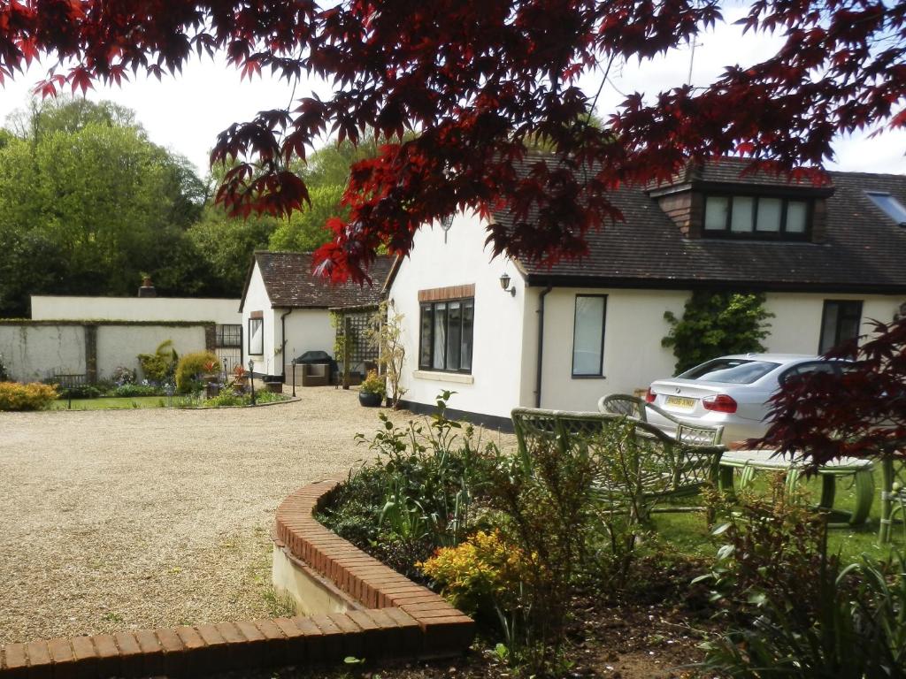 a house with a car parked in the driveway at Orchard Paddocks in Guildford