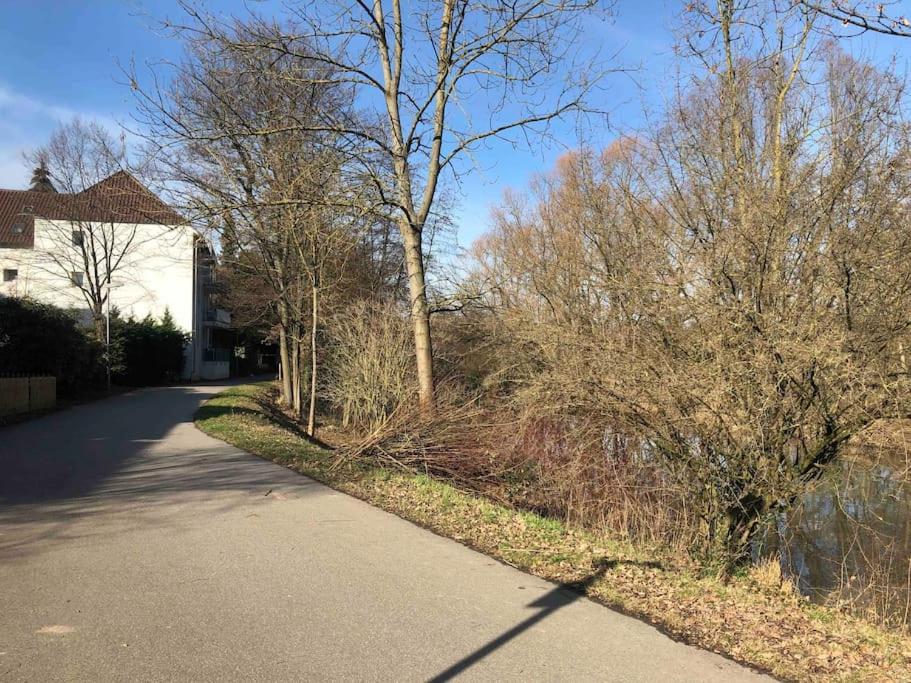 a road in front of a house with trees at Neues schönes Studio, zentral & direkt an der Rems in Waiblingen