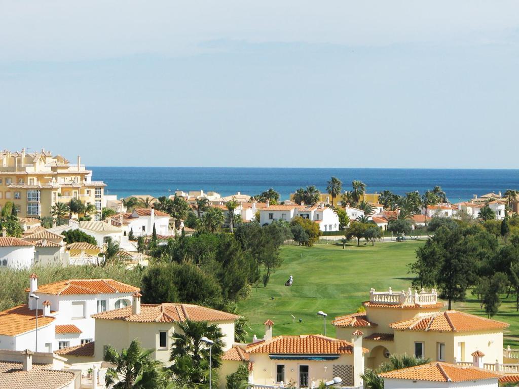 a view of a town with houses and the ocean at Villa Gaudi in Oliva