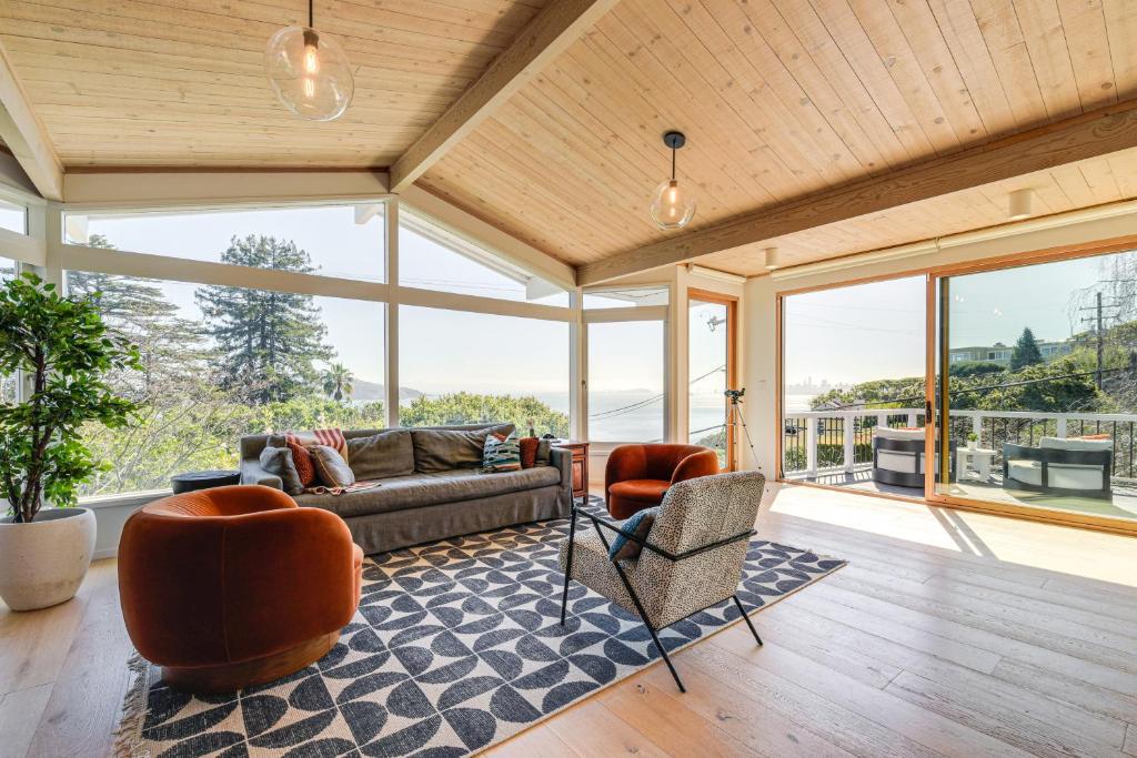 a living room with a couch and chairs and windows at Sausalito Oasis - 3 Mi to Golden Gate Bridge! in Sausalito