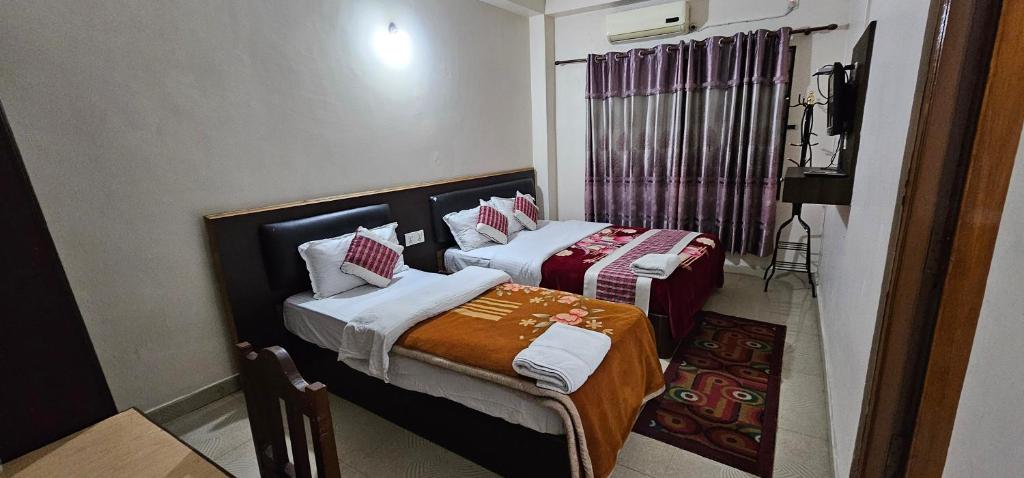 Rúm í herbergi á Hotel Simara