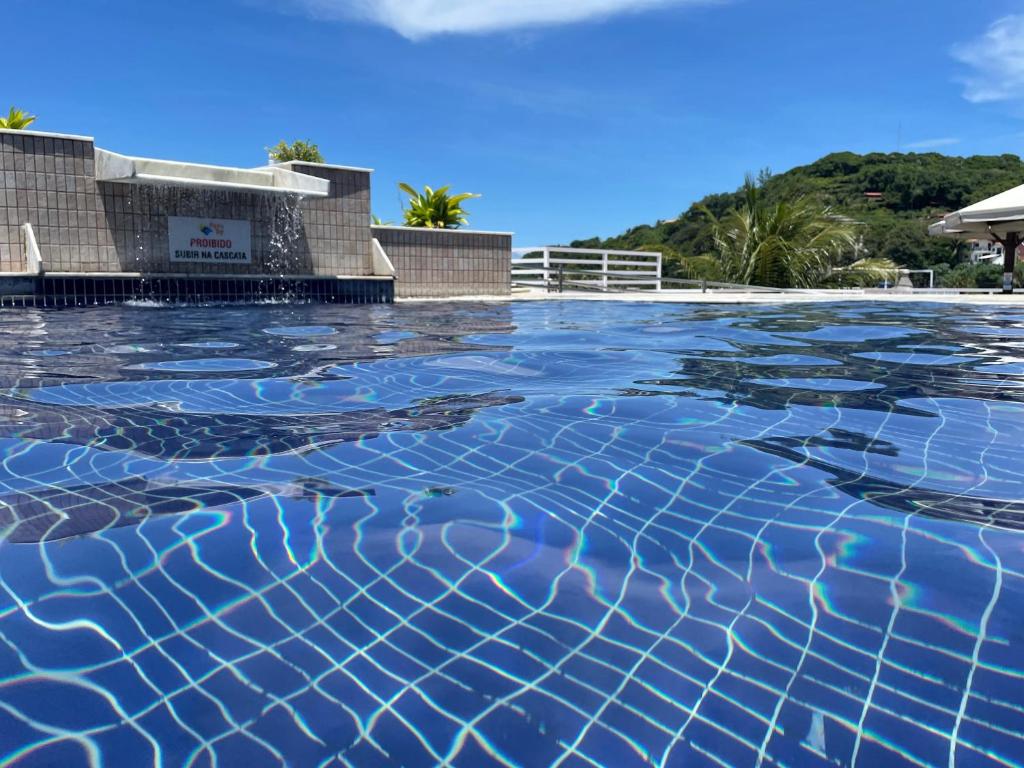 a swimming pool with blue water on top of it at Pipas Bay in Pipa