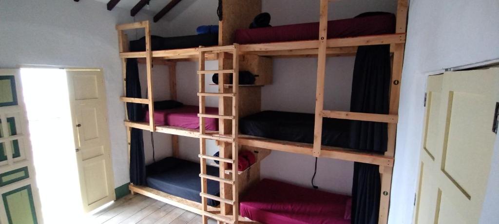 a room with four bunk beds in a room at Hostal El fin del afán in Jericó