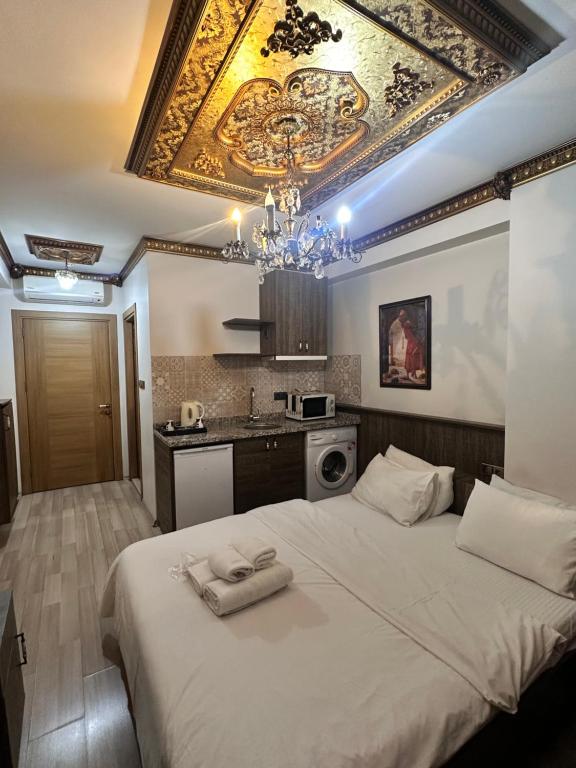 a bedroom with a large bed with a chandelier at Borancik hotel in Istanbul