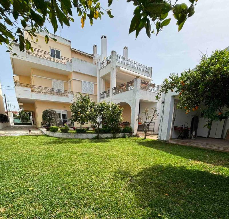 a large building with a lawn in front of it at LOFT HOUSE in Vrachati