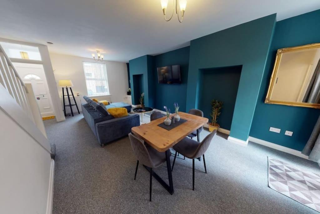 a living room with a table and a couch at Stockton House in Stockton-on-Tees