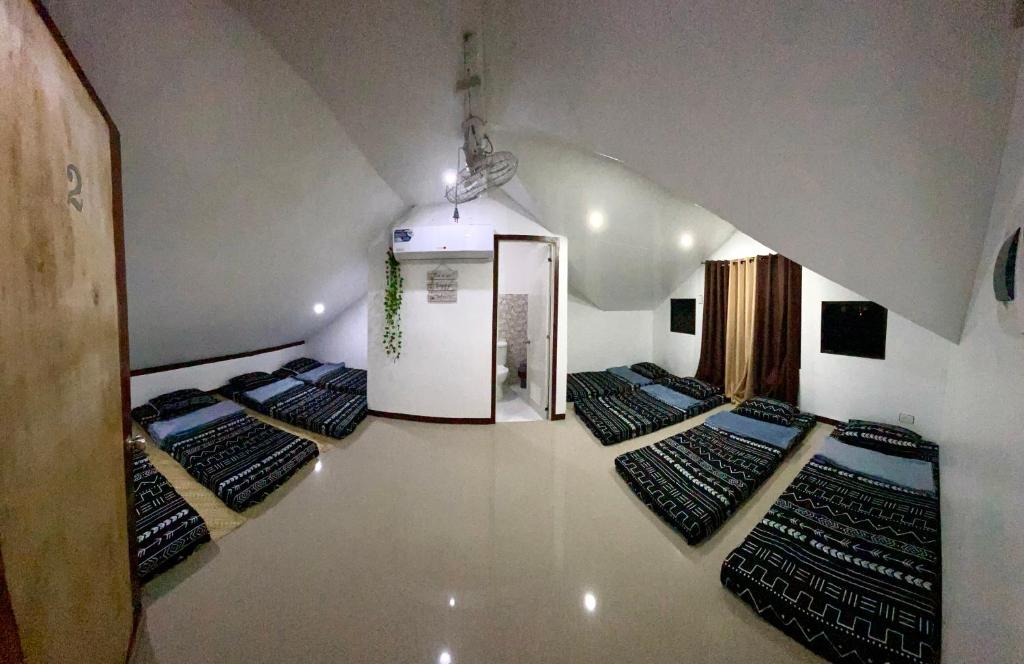 a room with a bunch of beds in a room at TopBudz Hostel Panagsama Moalboal in Moalboal