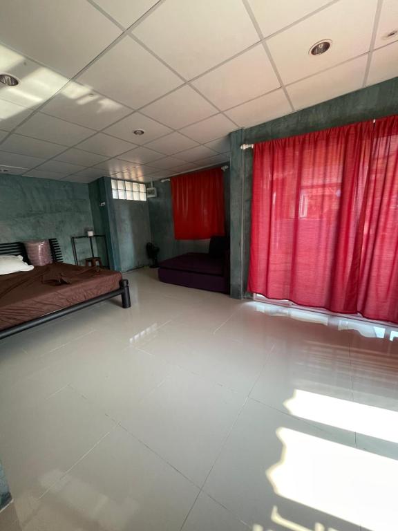 a room with a red curtain and a bed at C-Hill Camp&Resort in Mae Rim