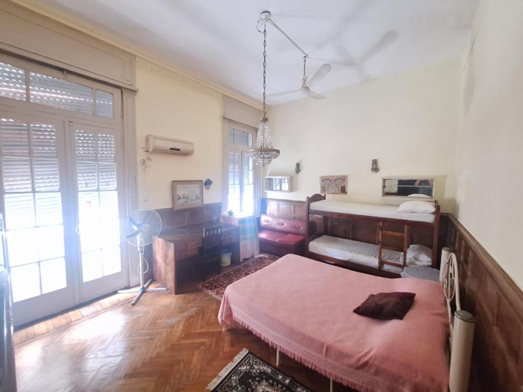 a bedroom with a bed and a desk in it at Aires de Tango Hostel in Buenos Aires