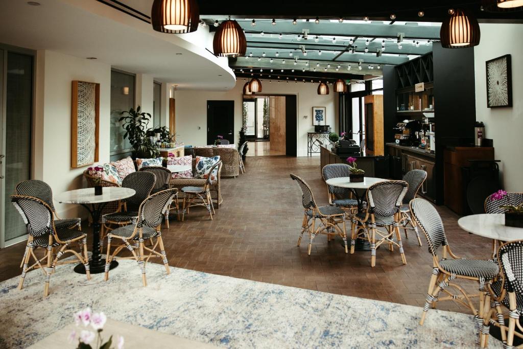 a restaurant with tables and chairs in a room at The Fontaine in Kansas City