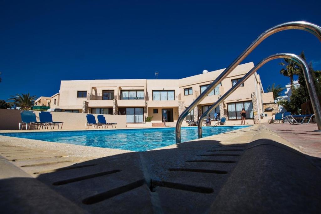 a swimming pool with a slide in front of a building at Ferienwohnung für 3 Personen ca 1 qm in Agia Napa, Südküste von Zypern - b58979 in Ayia Napa