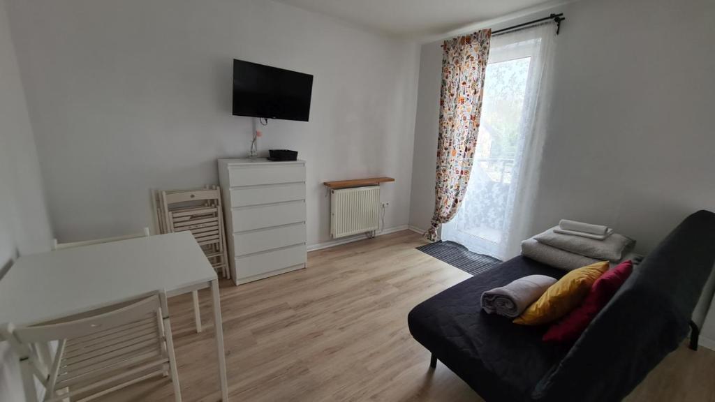 Televízia a/alebo spoločenská miestnosť v ubytovaní ALDAMI