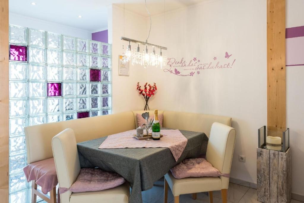 a dining room with a table and two chairs at 5 Sterne Ferienwohnung mit 2 Schlafzimmer, 2 Bäder, Badewanne und eigener Infrarotsauna in Arnbruck