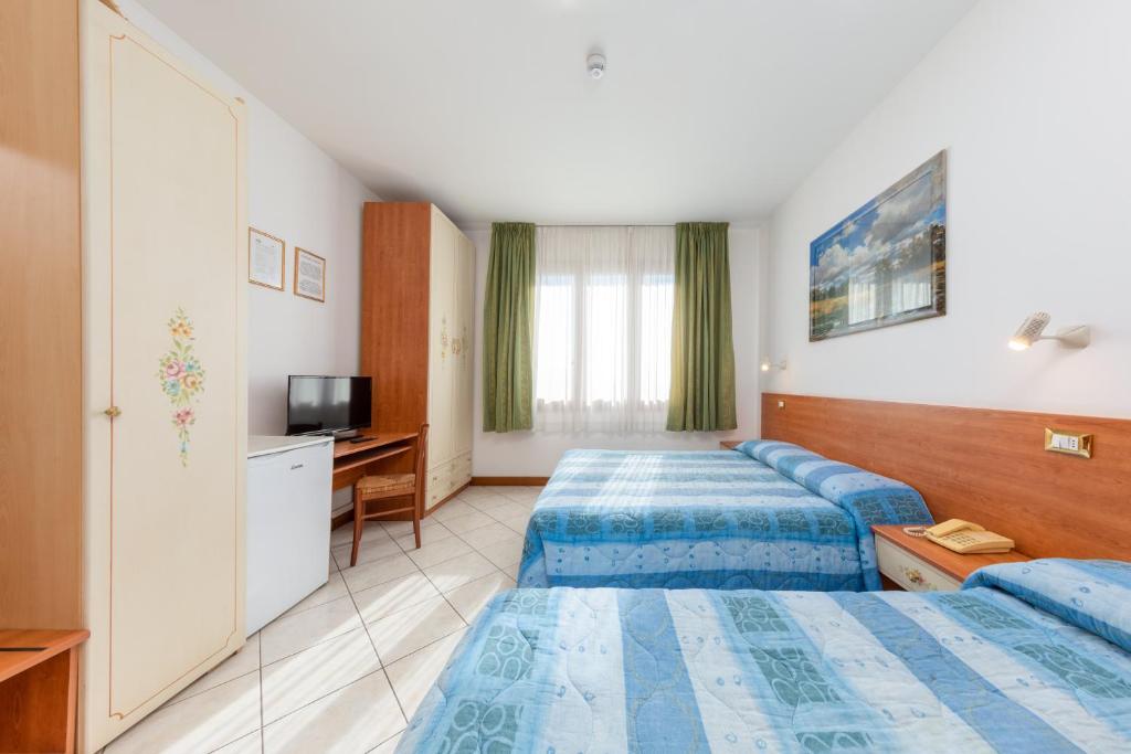 Posteľ alebo postele v izbe v ubytovaní Hotel New Aurora Venice
