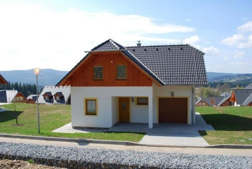 a red and white house with a garage at Ferienhaus für 8 Personen ca 200 qm in Slupecna, Böhmen Moldau in Lipno nad Vltavou