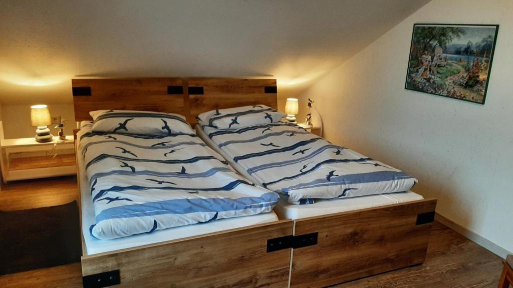 Schlafzimmer mit einem Bett mit einem Kopfteil aus Holz in der Unterkunft Gemüsekombüse in Ramstedt