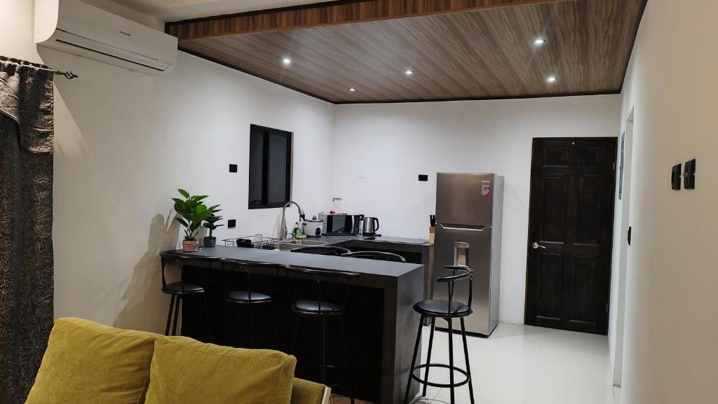 a kitchen with a sink and a refrigerator at CASA TRES RIOS EN OSA in Coronado