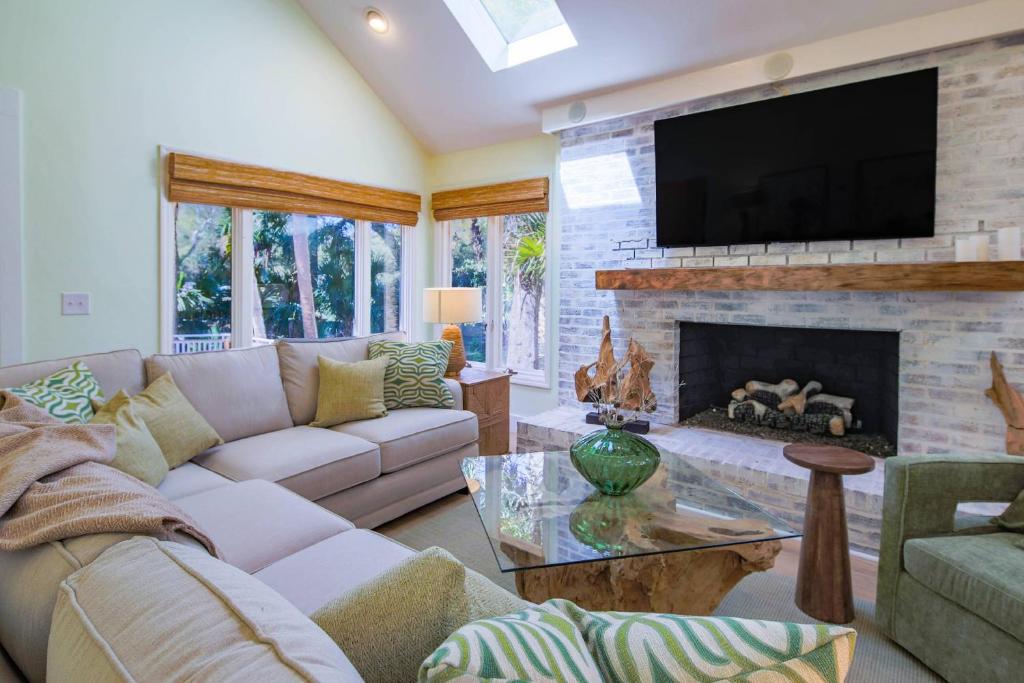 a living room with a couch and a fireplace at Nature’s Haven in Kiawah Island