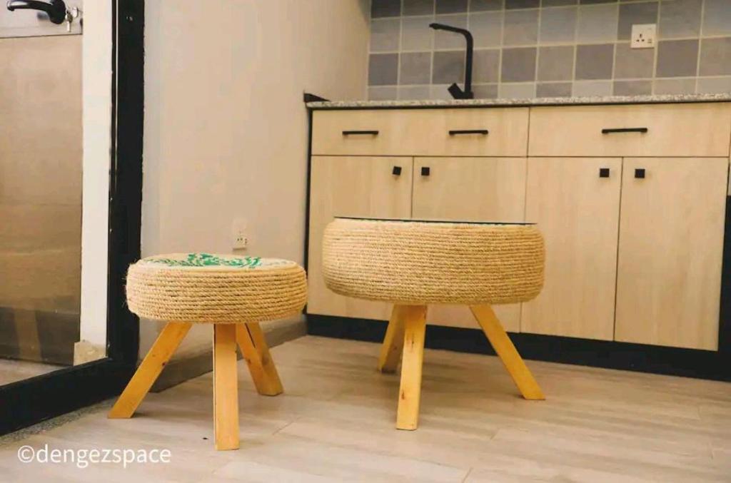 a kitchen with two stools and a sink at Royal Milk pipeline apartment in Addis Ababa