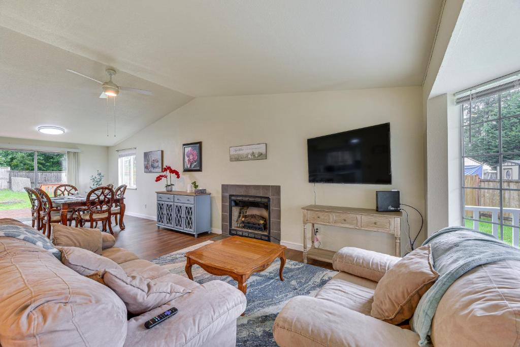 a living room with two couches and a fireplace at Olympia Home with Deck about 7 Mi to Amtrak Train! in Olympia