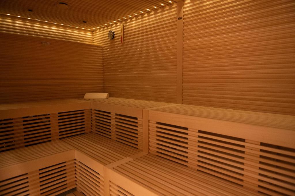 an empty sauna with wooden panels and lights at Hotel President in Lignano Sabbiadoro