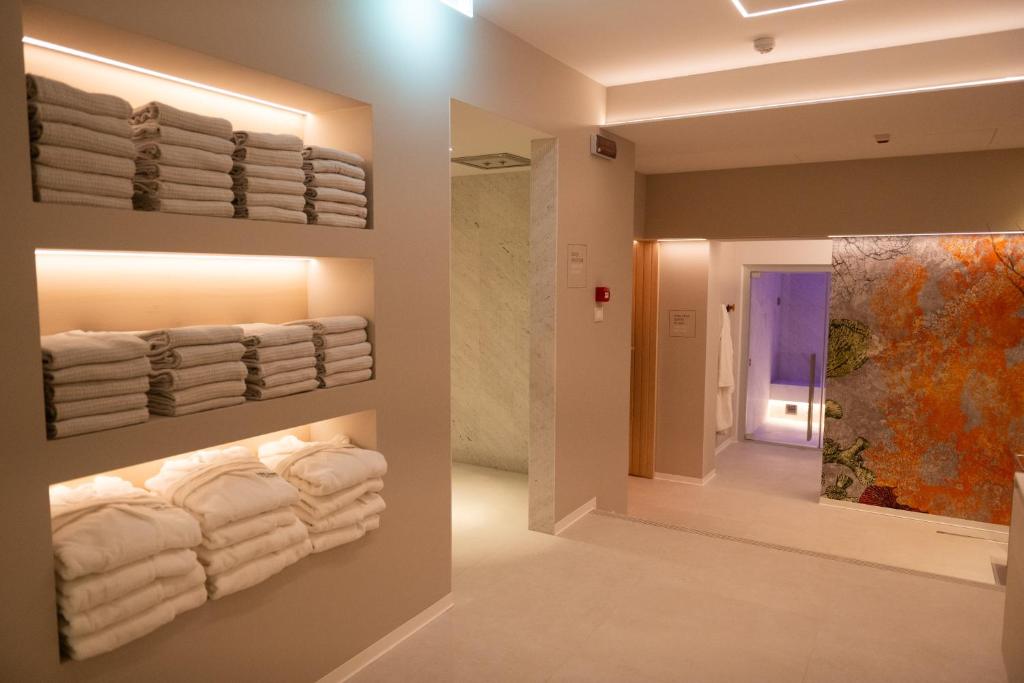 a bathroom with white towels on a wall at Hotel President in Lignano Sabbiadoro