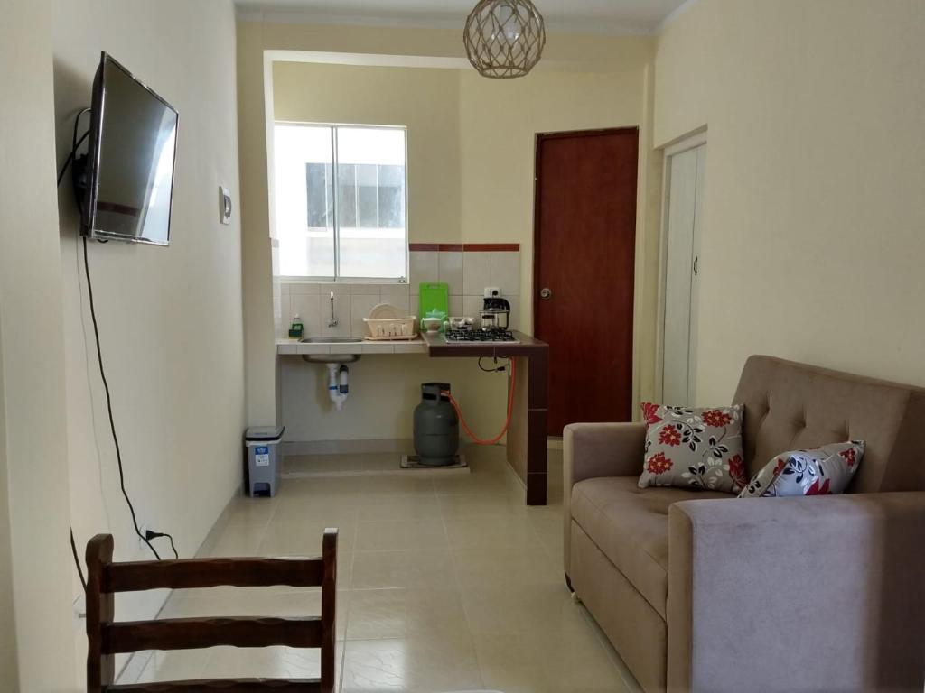 sala de estar con sofá y TV. en LA CASA DE LA ABUELA, en Barranca