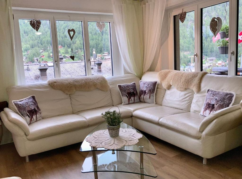 a living room with a couch and a table at Bodmen 3 Apartments von Privat in Zermatt in Zermatt
