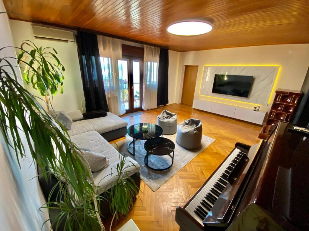 a living room with a piano and a couch at SLAVANTE RESIDENCE in Rijeka