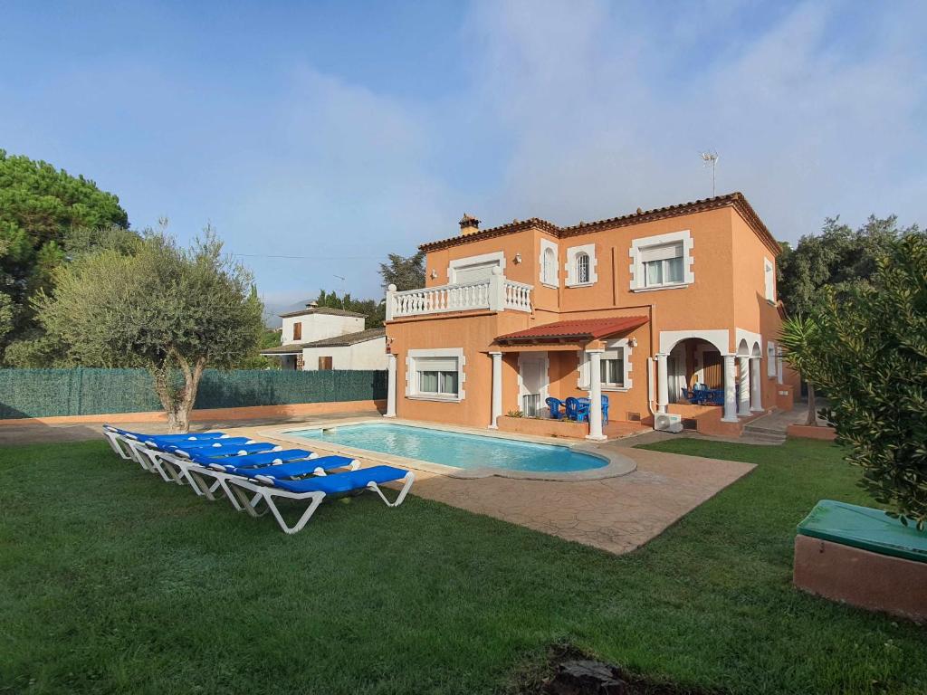 a villa with a swimming pool and a house at Costa Brava Suites Villa Cèsar in Calonge