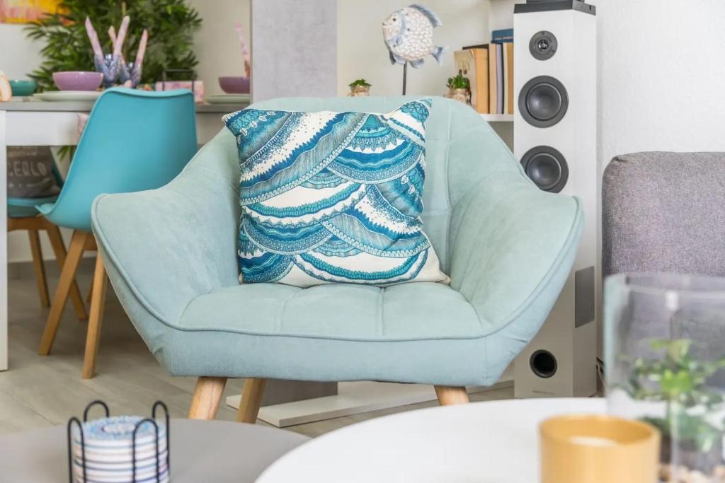 a blue chair with a throw pillow on it at Skyline 21 in Torrevieja