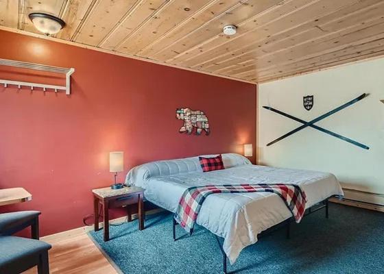 a bedroom with a bed and a red wall at Lift Landing in Idaho Springs