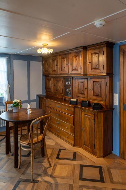 a kitchen with wooden cabinets and a wooden table at Peterhof Sarnen in Sarnen