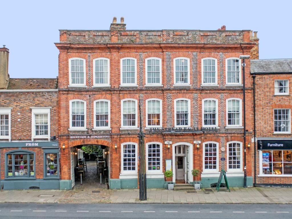 a large red brick building with white windows at The Spread Eagle Hotel in Thame