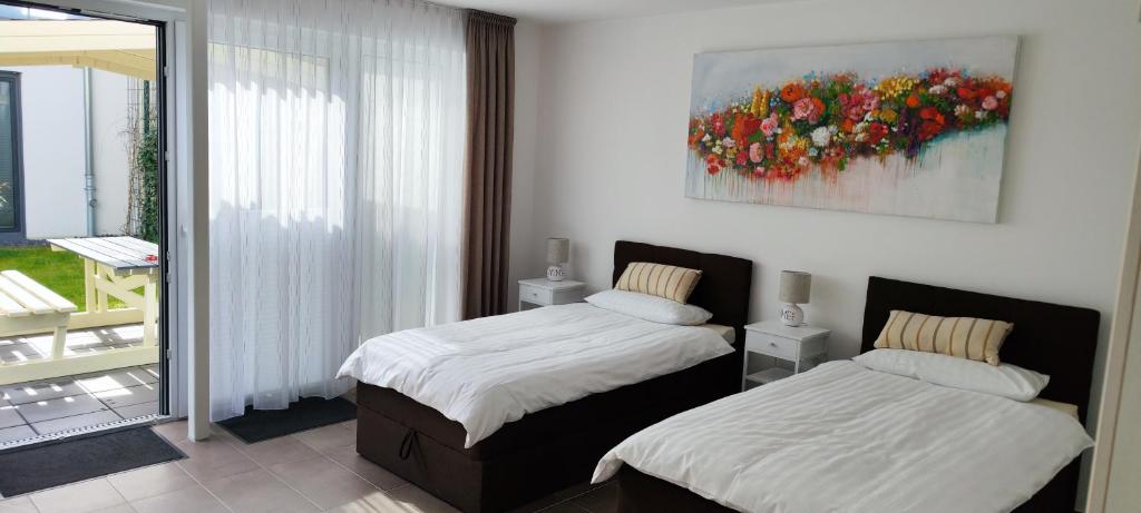 1 dormitorio con 2 camas y un cuadro en la pared en Apartment.Abel-Misburg en Hannover